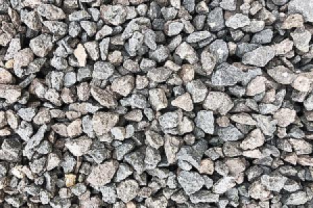 Runde, graue und braune Drainagekies-Steine in unterschiedlichen Größen, gleichmäßig verteilt.