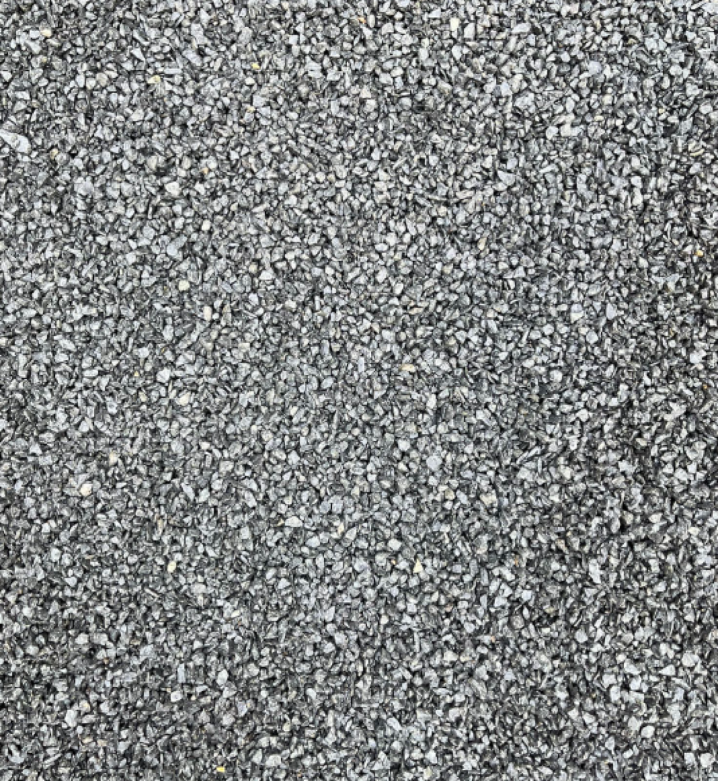 Basaltsplitt von Hünten GmbH, gleichmäßig verteilte, graue Gesteinskörner großflächig abgebildet.