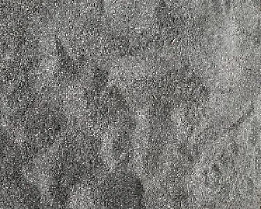 Feinkörnige graue Basaltsand-Textur, gleichmäßig verteilt, natürliche Oberfläche.