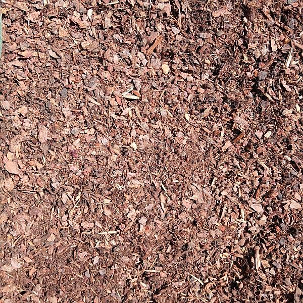 Rindenmulch aus Kiefernholz, Markenprodukt Florikomp, gleichmäßig verteilte Holzstückchen in verschiedenen Brauntönen.