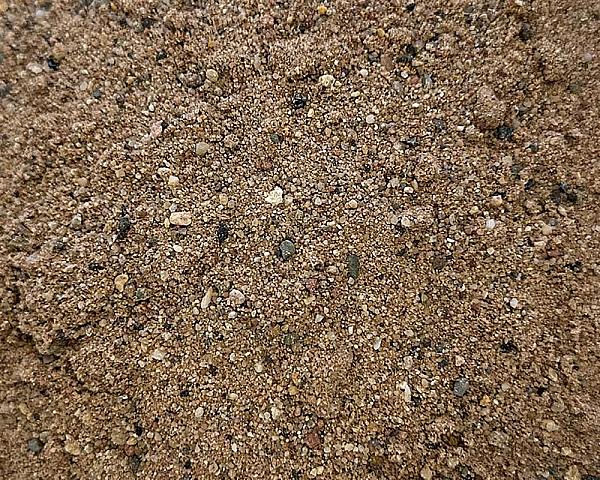 Sand mit feiner Körnung und vereinzelten kleinen Steinen, Farbe naturbelassen.