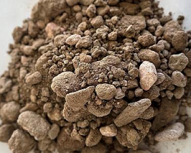 Haufen aus grobem, grauem Füllkies, bestehend aus verschiedenen Korngrößen der Marke Volz und Herbert GmbH.